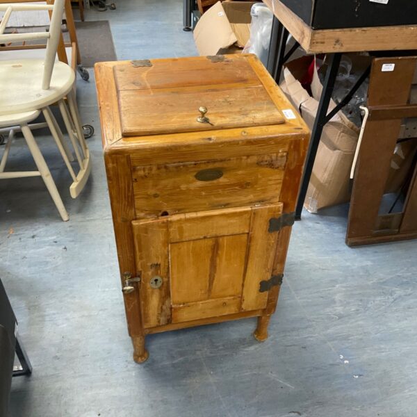 Antique wooden refrigerator box with a weathered patina.