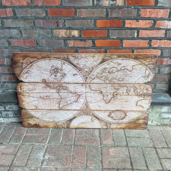 Detailed antique world map print on wooden panels.