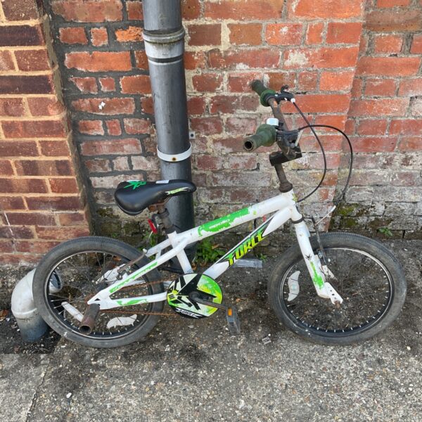 White and green Apollo Force BMX bike for children.