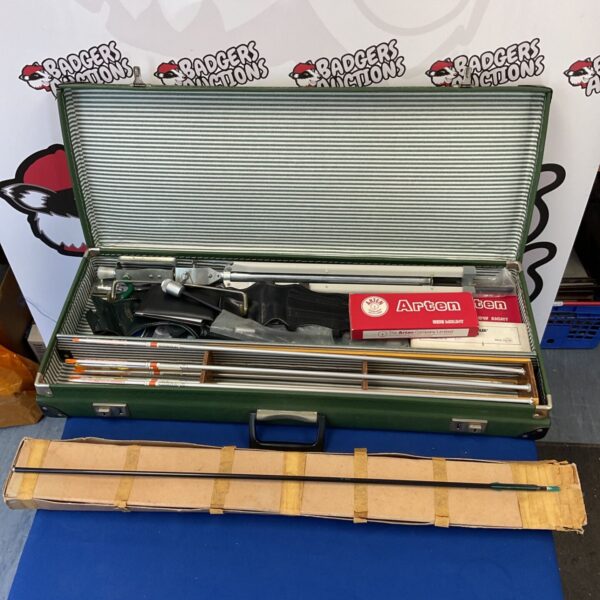 Vintage archery accessories case with arrows and bow sights inside.