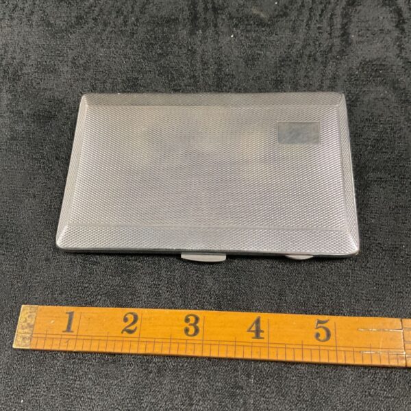 Silver plated Art Deco cigarette case with geometric pattern.