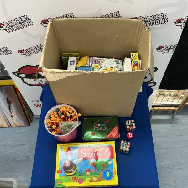 Assorted toys and games lot including board games and building sticks.