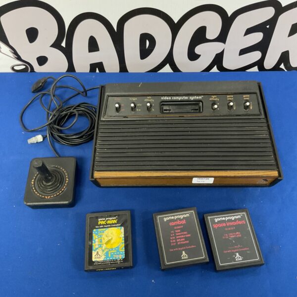 Vintage Atari Video Computer System console with joystick and game cartridges.