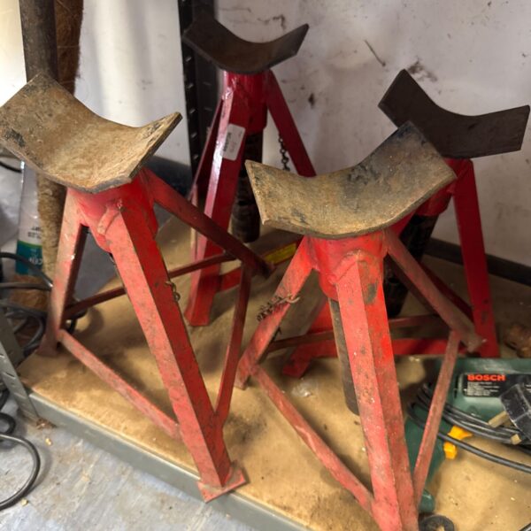 Pair of used metal axle stands for vehicle maintenance.