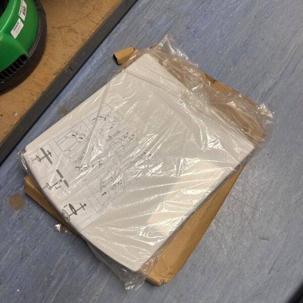 New Bath Empire toilet seat in plastic packaging, ready for installation.