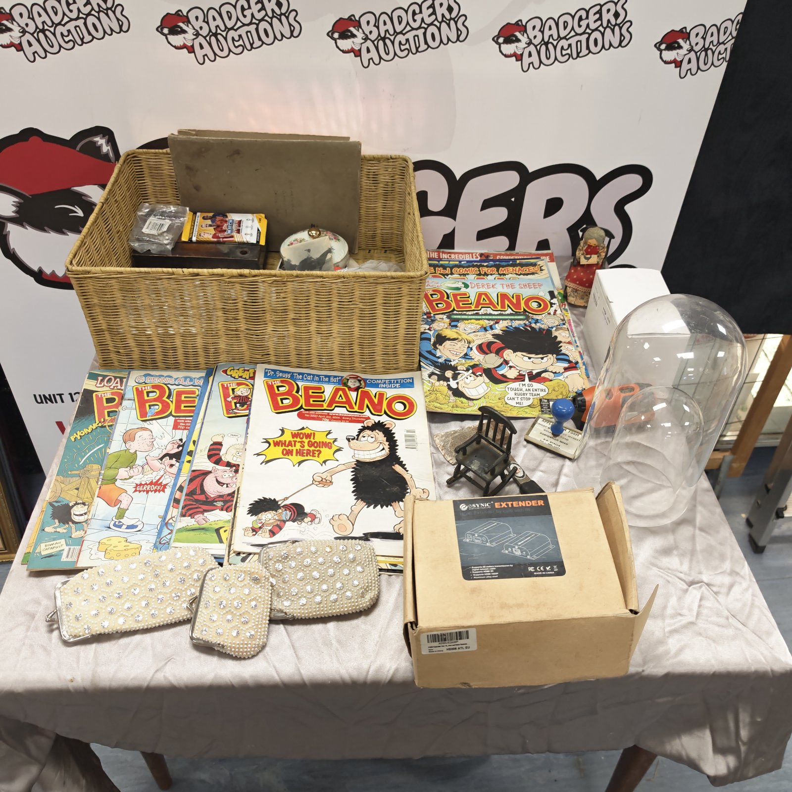 Wicker basket filled with Beano comics and an HDMI extender.