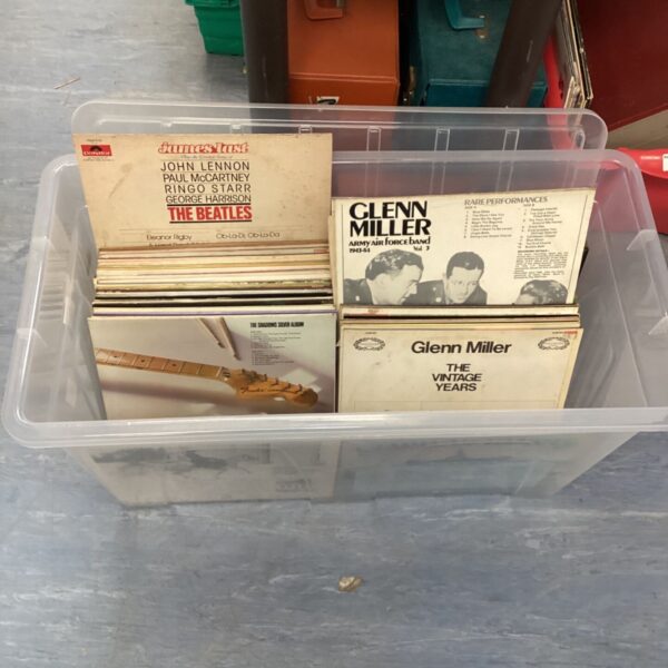 Large vinyl record collection featuring Beatles and Glenn Miller records.