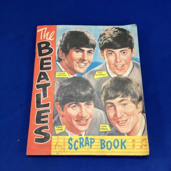 Vintage Beatles scrapbook cover with band member photos.