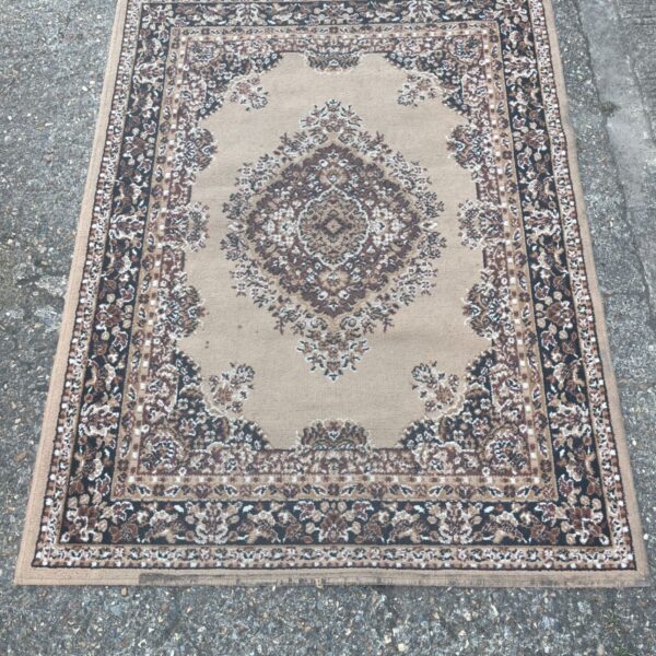 Traditional beige and brown area rug with medallion design.