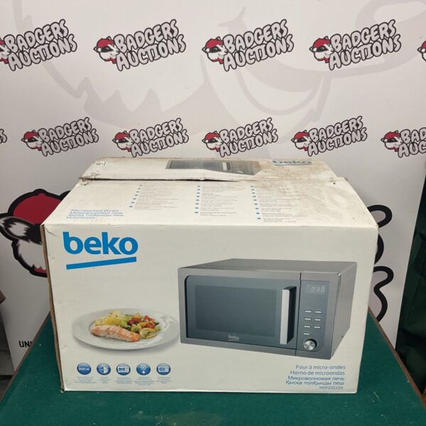 Front view of a used Beko microwave oven with digital display.