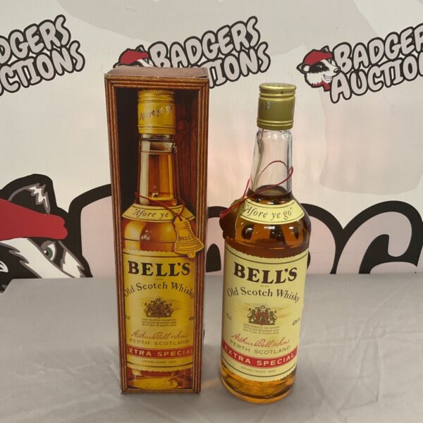 Vintage bottle of Bells Extra Special Scotch Whisky with label.