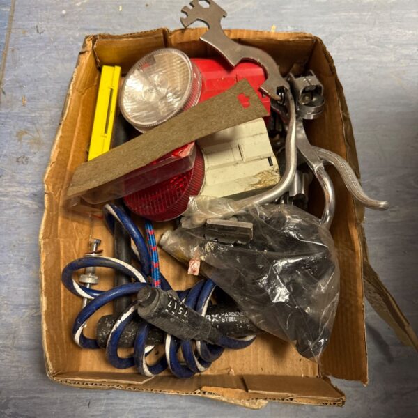 Tray of assorted vintage bicycle parts and components for repair.