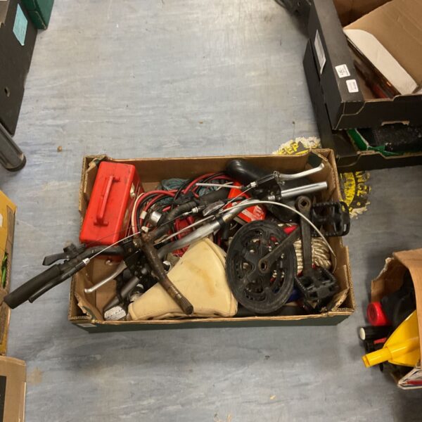 Assorted bike parts lot including handlebars and pedals.
