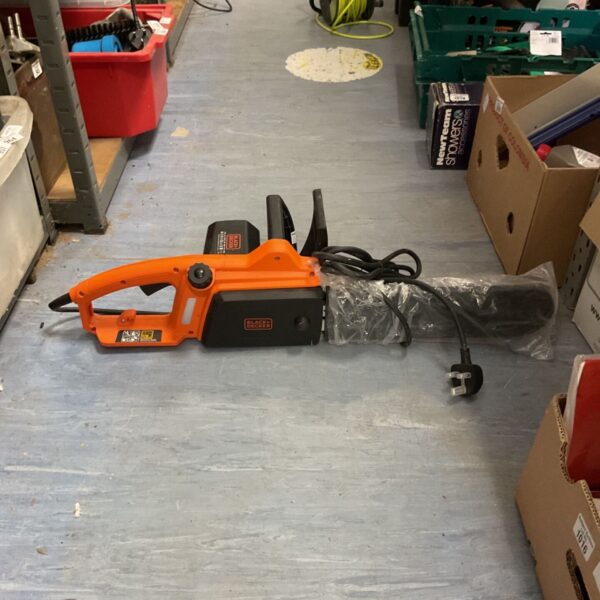 Black and Decker corded electric chainsaw in used condition.