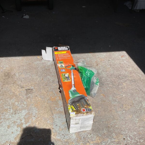 Black and Decker cordless strimmer in original packaging, garden tool.