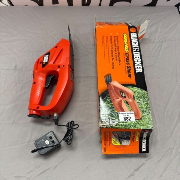 Black & Decker cordless grass shear with two-pin plug, garden tool.