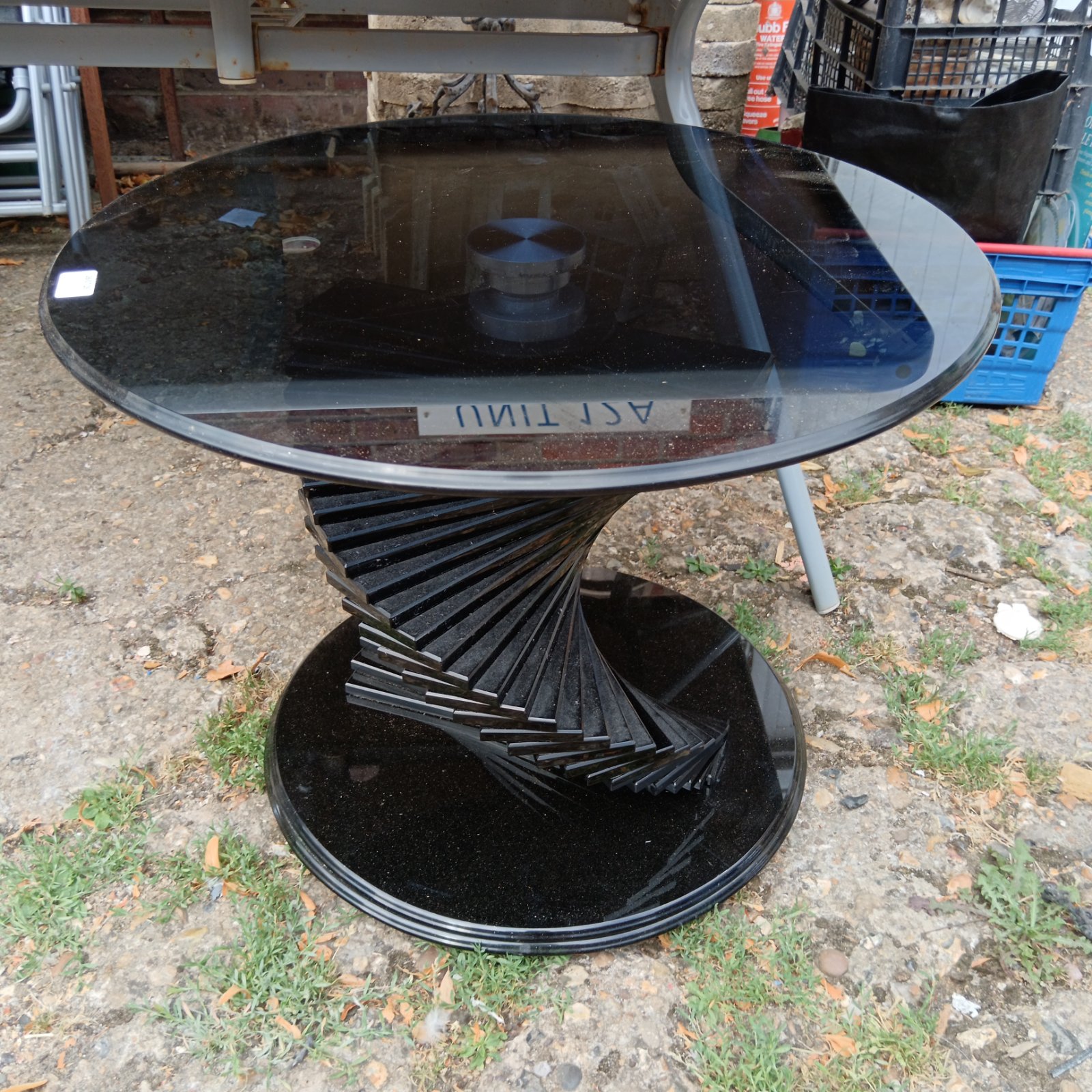 Black glass designer side table for magazines and display.