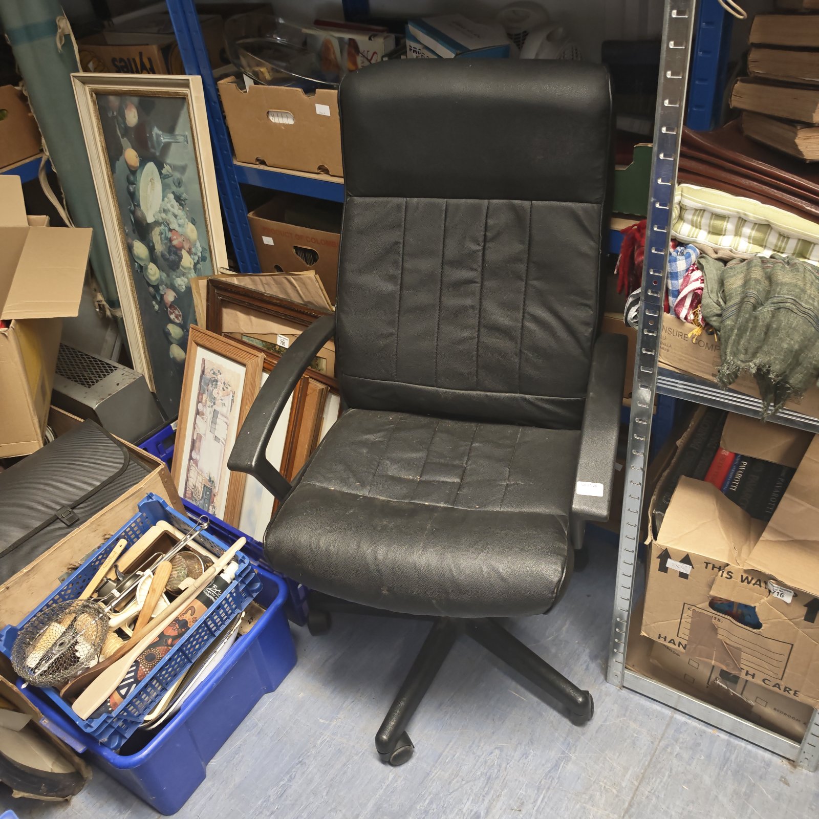 Black office swivel chair with a padded seat and backrest.