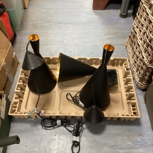 Black industrial pendant lights with conical shades.
