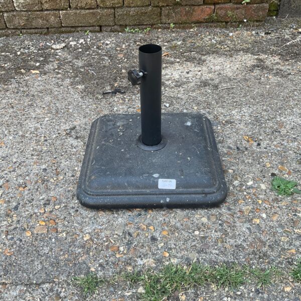 Black square umbrella stand for patio use.