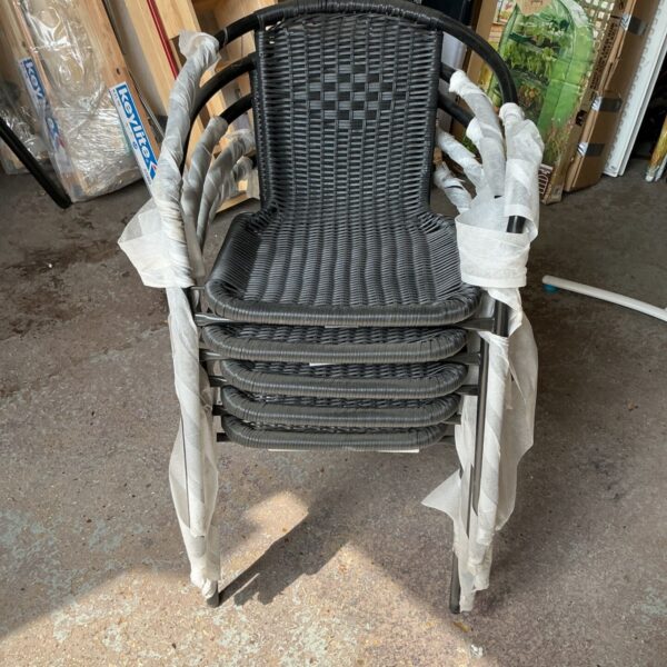 Set of five black wicker chairs for outdoor patio use.