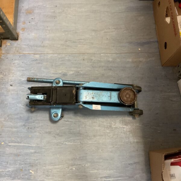 Vintage blue hydraulic floor jack for automotive repair.