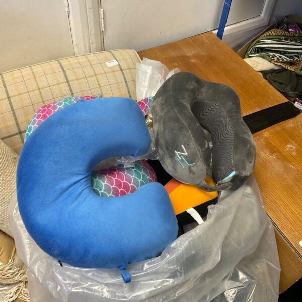 Blue padded neck rest for travel comfort and support.
