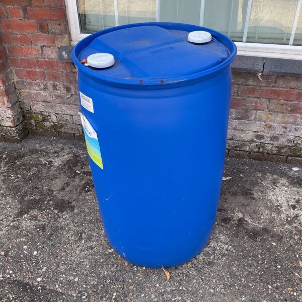 Blue plastic drum for AdBlue storage, showing wear.