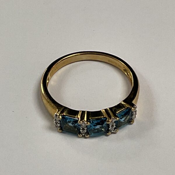9ct gold ring with three blue topaz stones.
