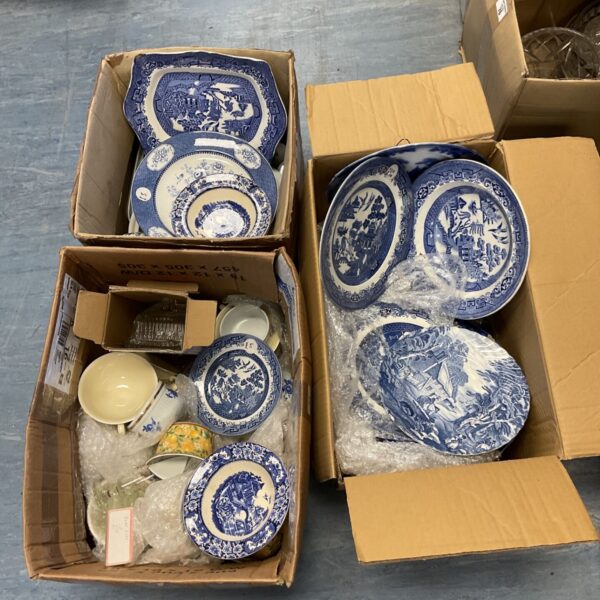 Three boxes of vintage blue willow pattern china plates and bowls.