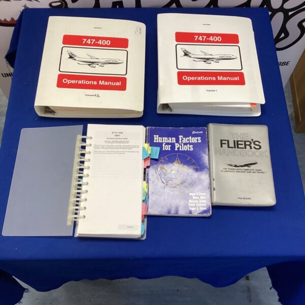 Boeing 747-400 operations manuals and fliers handbook displayed.