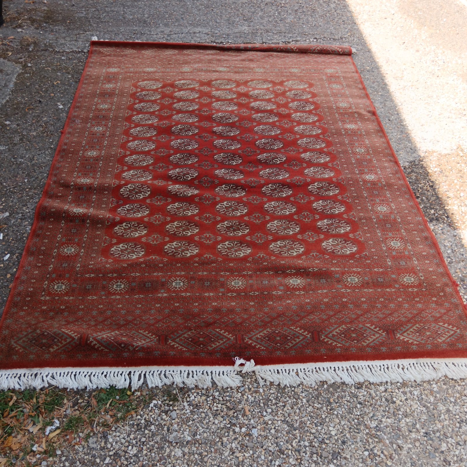 Red Bokhara rug with intricate geometric floral patterns.