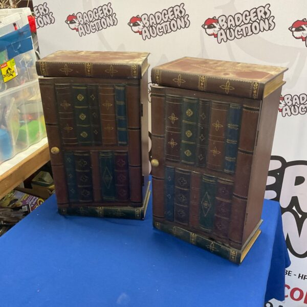 Pair of book-shaped storage units for CDs and DVDs.