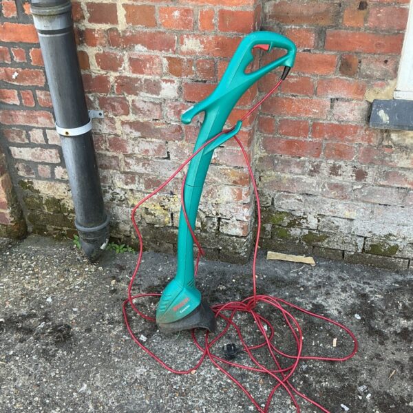 Bosch EasyTrim electric strimmer in used condition for garden maintenance.