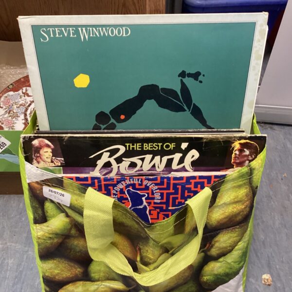 Vinyl records by David Bowie and Steve Winwood in a collection.