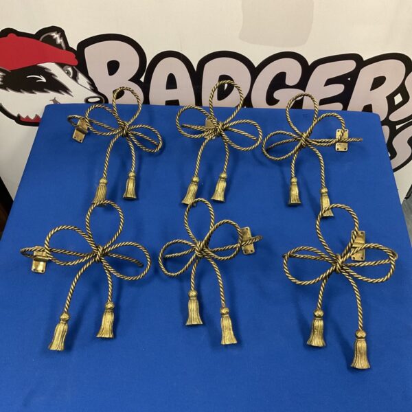 Vintage brass curtain tiebacks with a twisted rope design.