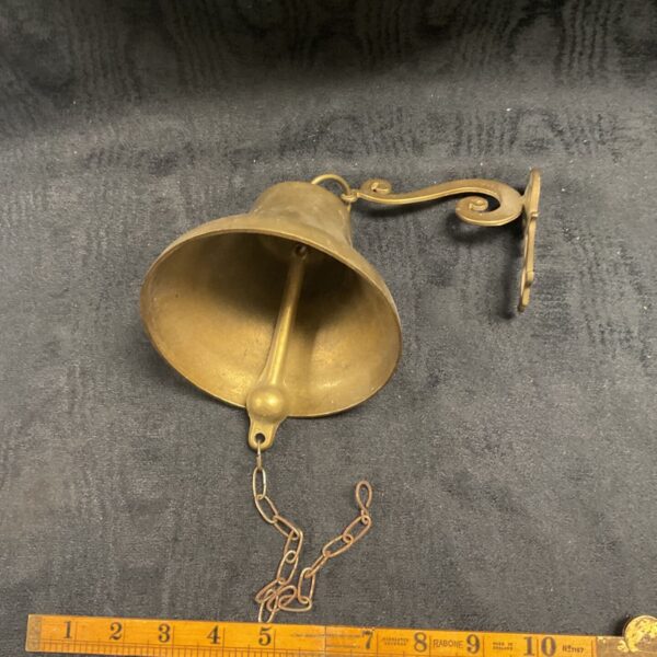 Vintage brass doorbell with chain, a classic antique home feature.