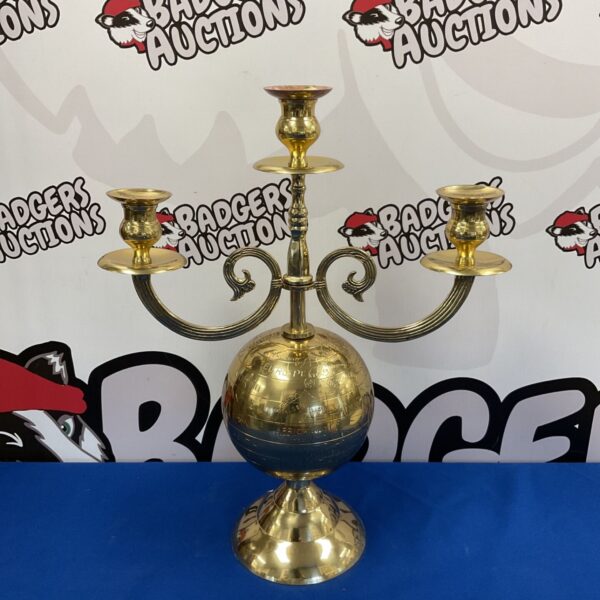 Vintage brass globe candelabra with three candle holders.