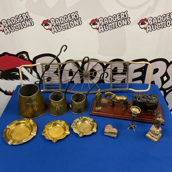 Vintage brassware collection featuring cider measures and Welsh miner figurine.