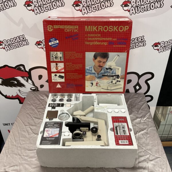 Boxed Bresser Optik microscope with accessories for scientific observation.