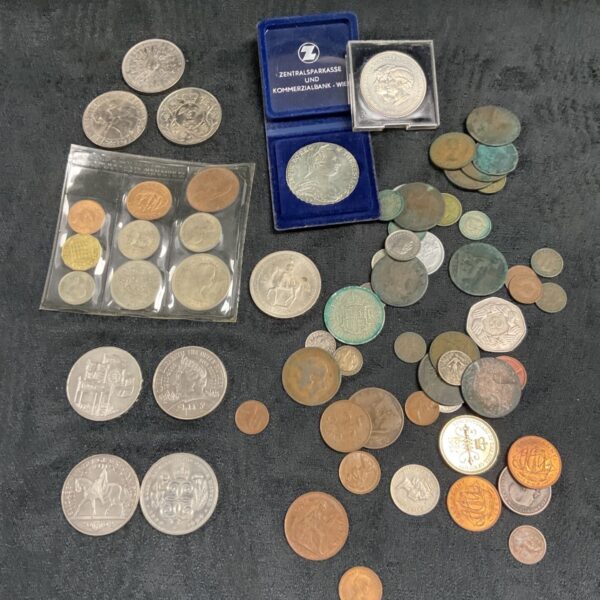 British coin collection including £5 coins and various denominations.