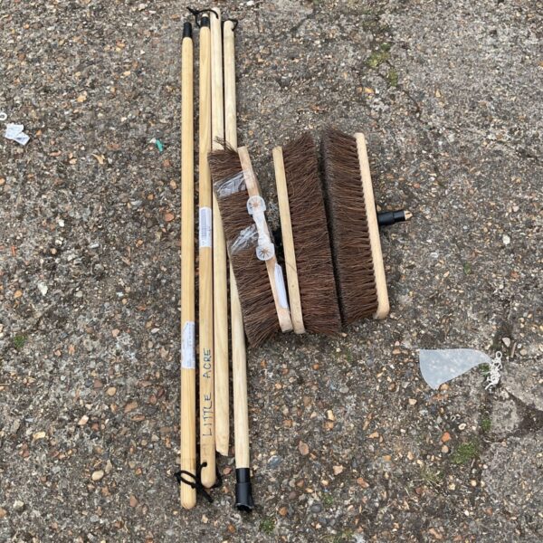 Job lot of vintage broom heads and wooden handles for cleaning.