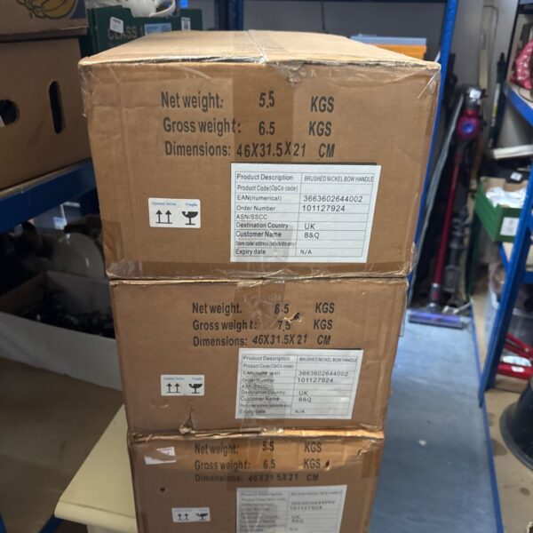 Sealed boxes of new brushed nickel bow handles for cabinets.