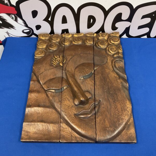 Detailed carved wood Buddha wall art panel for Asian-inspired decor.
