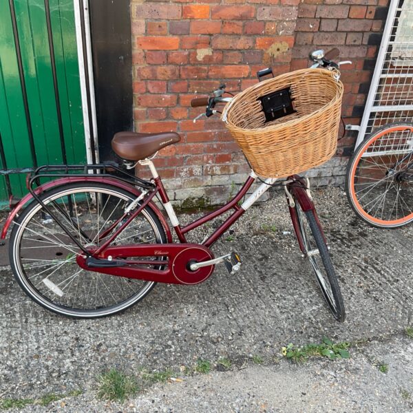 Burgundy Halfords Real Classic ladies bike with wicker basket.