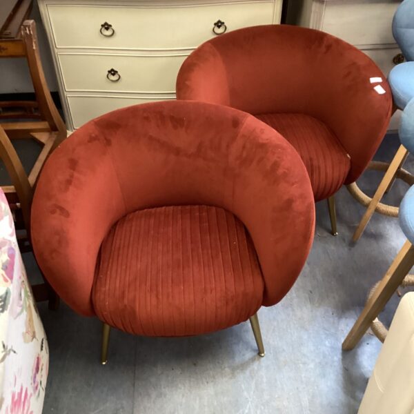 Pair of burgundy velvet tub chairs in a vintage style.