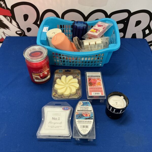 Basket of assorted candles and wax melts including Yankee Candle.
