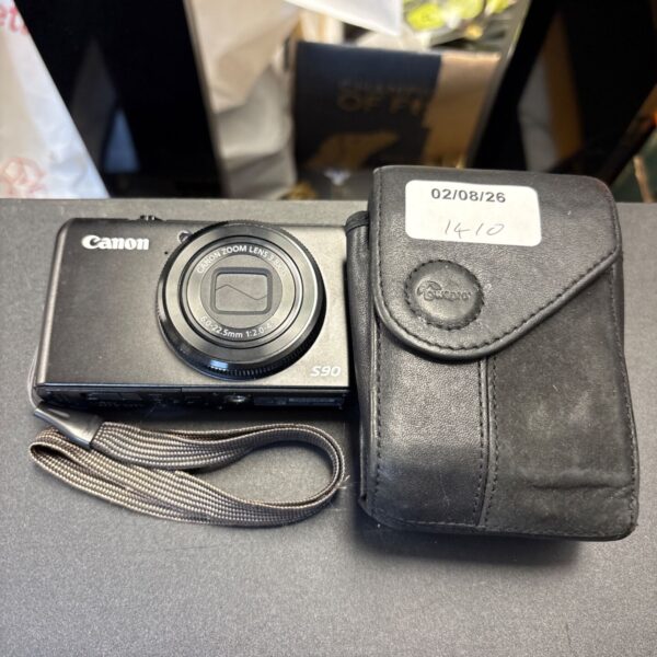 Canon PowerShot S90 digital camera in protective case.