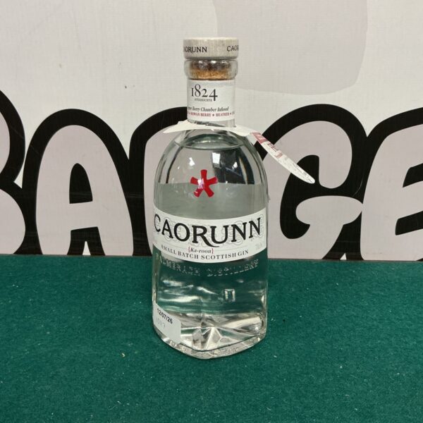 Bottle of Caorunn Scottish Gin with a green background.