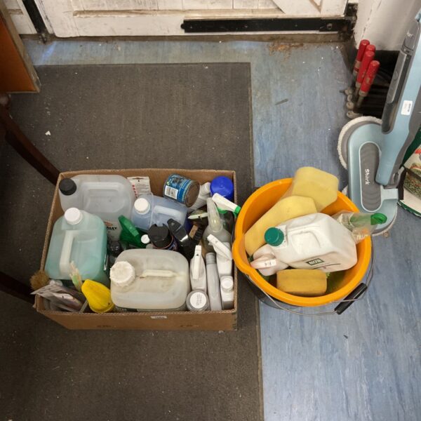 A box and bucket filled with various car cleaning supplies.